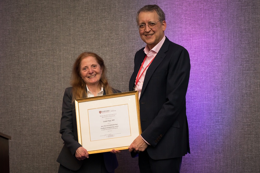 Linda Dagi receiving her award from David Hunter